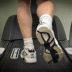 Sports podiatrist using a treadmill for gait analysis