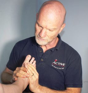 Tim Veysey-Smith examining a patient's foot