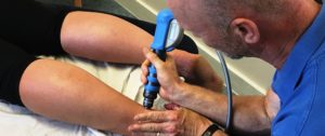 Patient receiving Shockwave Therapy treatment for a tendon injury