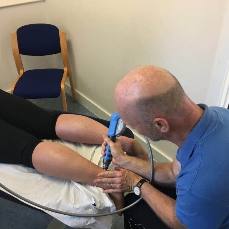 Patient receiving Shockwave Therapy treatment for a tendon injury